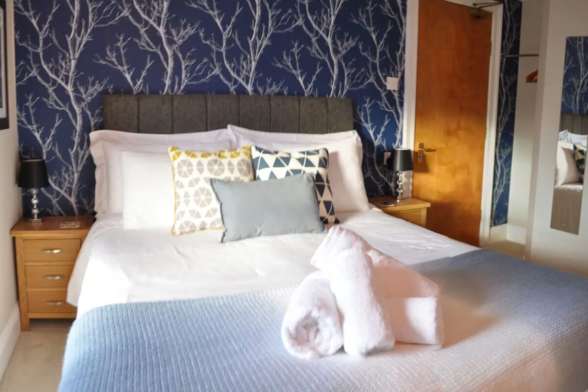 Room 3 - king size bed, ensuite shower, toilet and sink. This top floor room has views over the rear courtyard and views towards Walla crag.