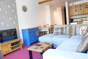 Open plan kitchen/dining/living area with dining table seating 6