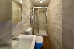 Room 2 – Modern ensuite with walk-in shower and contemporary fittings.