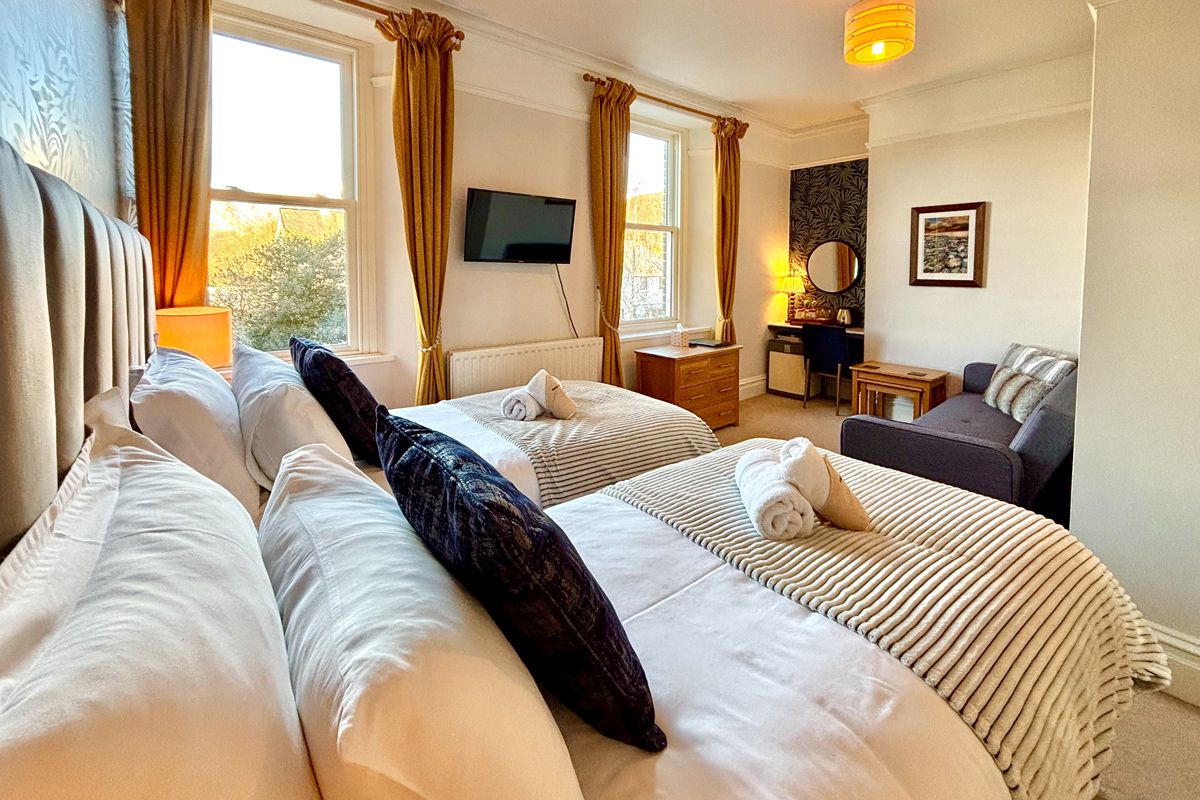 Room 2 – Twin room with plush beds and wide views across Keswick.